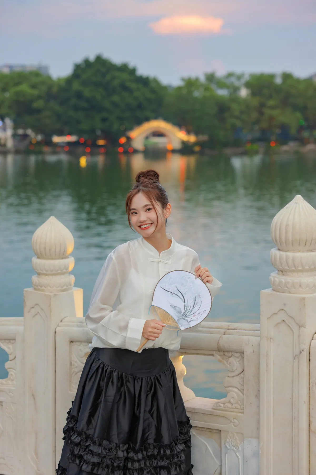 Wingkeh enjoying a cultural experience beside the river at sunset